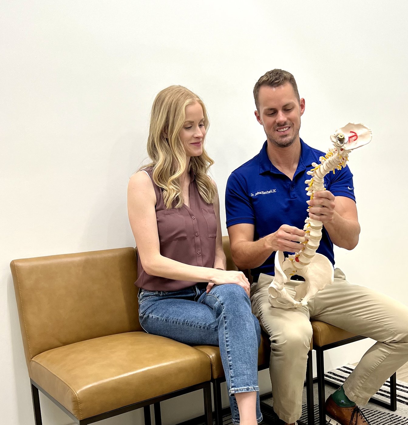 Dr. Josh Blanchard explaining spinal anatomy to a patient
