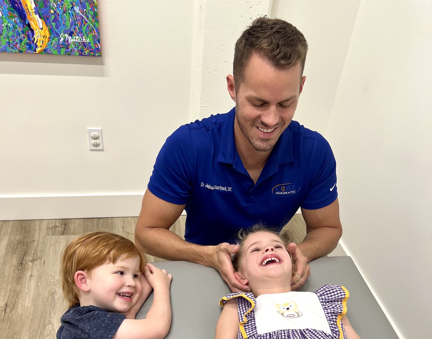 Dr. Josh Blanchard with two young patients at Core Chiropractic